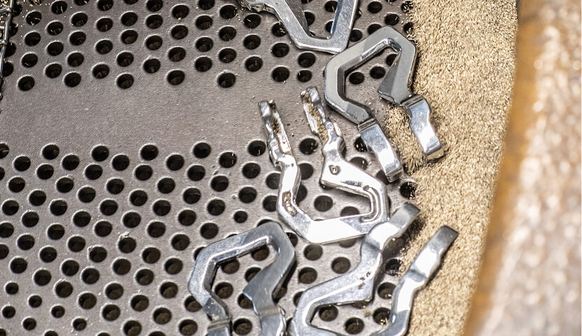 shot peening of ski boot hook arms